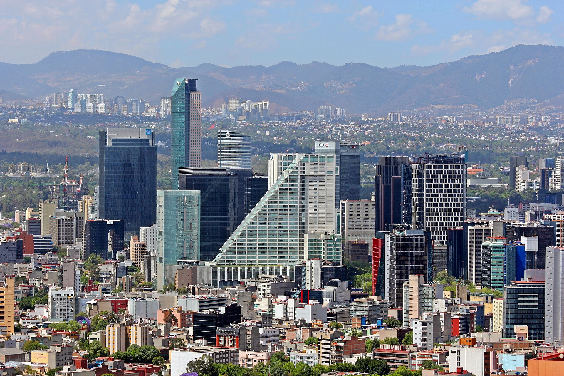 Skyline of office towers along Paseo de la Reforma in Mexico City, with mountains in the background