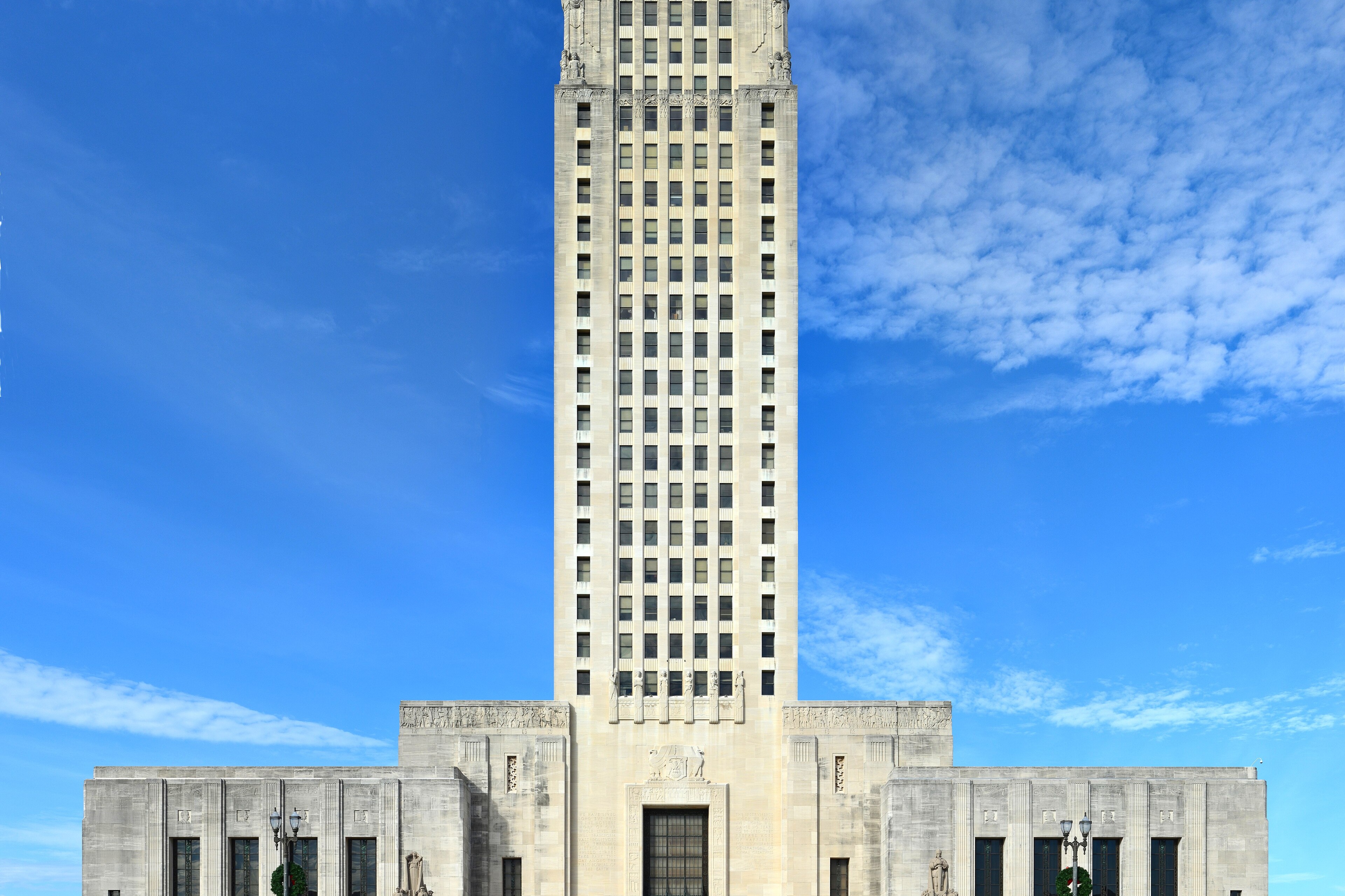 The Louisiana State Capitol tower and main entrance in Baton Rouge under a blue sky