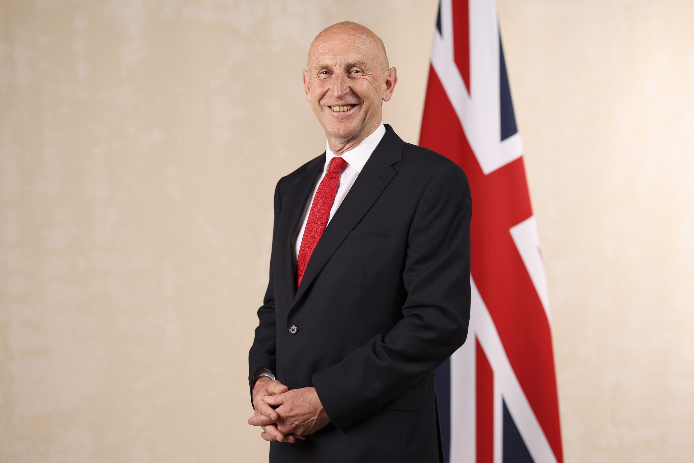 Chancellor of the Exchequer John Healey in his official cabinet portrait, standing in front of a Union flag