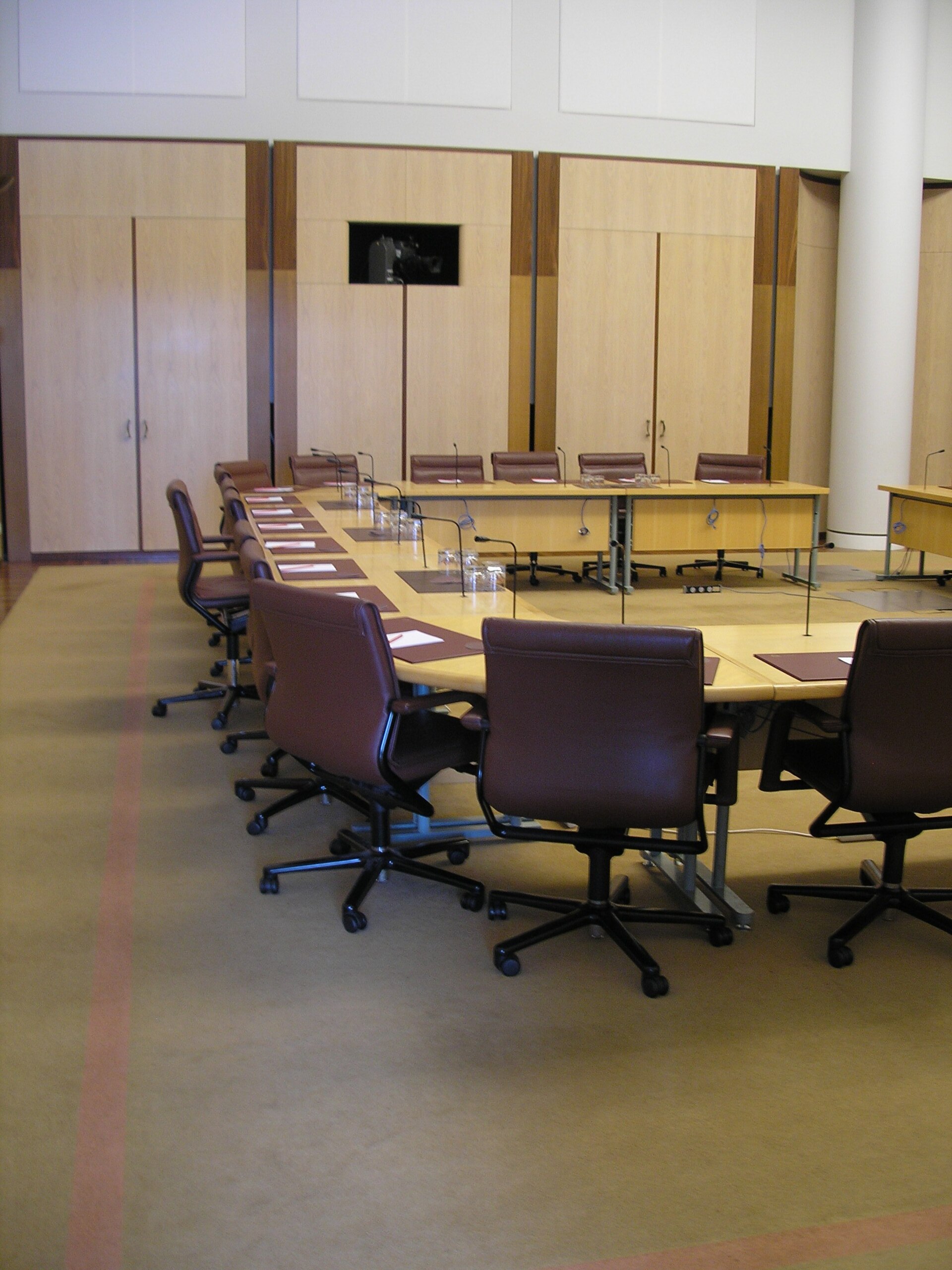 Desks and chairs in a Senate committee room at Australia's Parliament House in Canberra