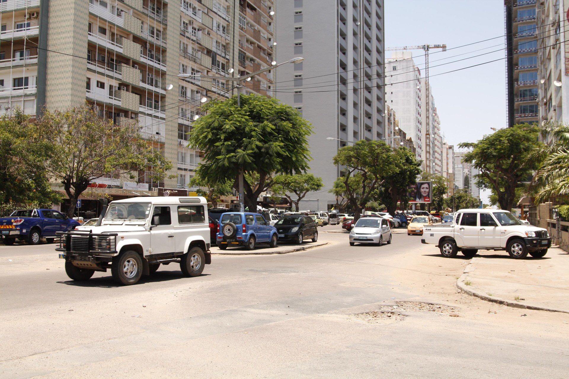 Traffic and tree-lined high-rise apartment blocks on Avenida Julius Nyerere in Maputo, Mozambique