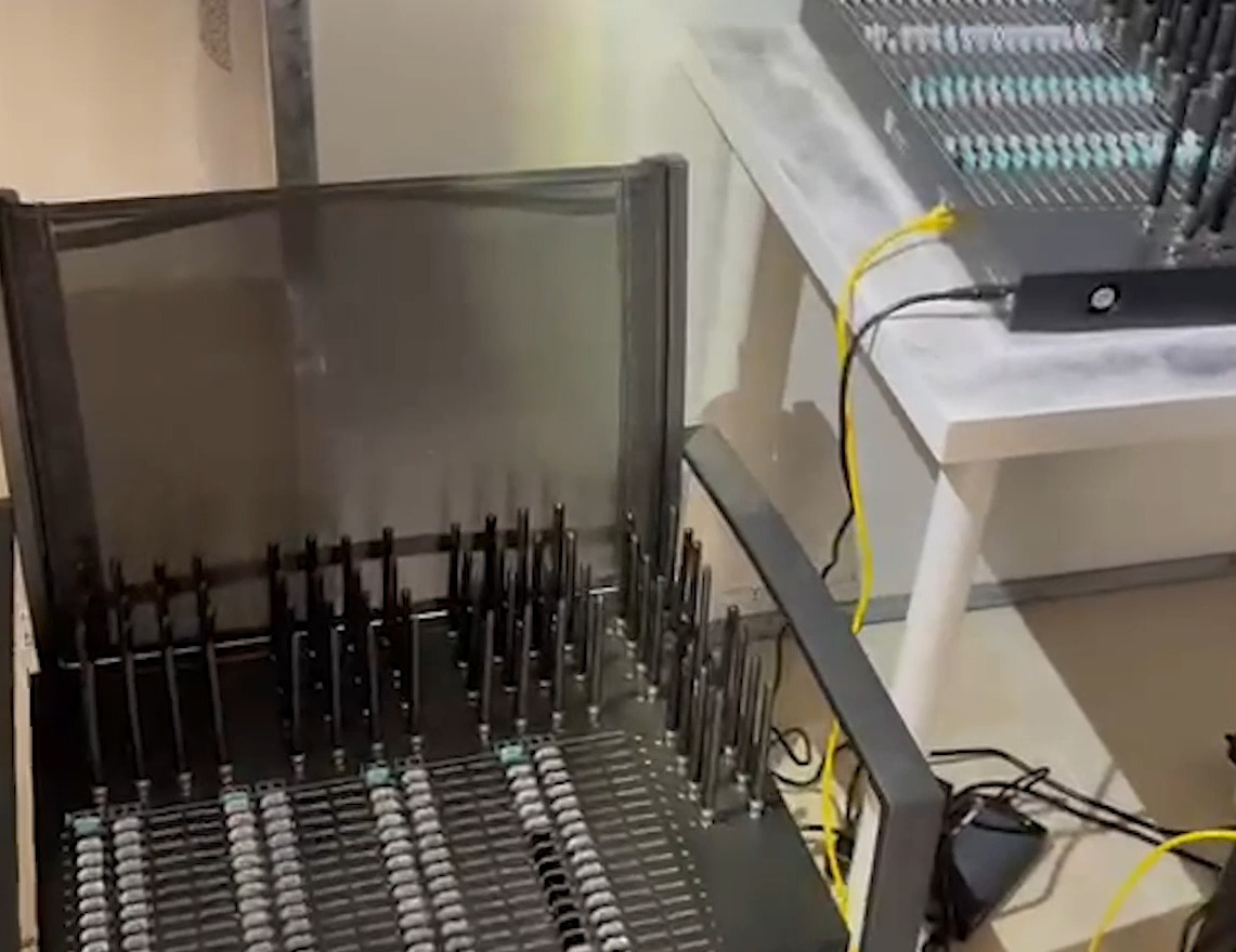 Racks of GSM modem pools with rows of SIM card slots and antennas, used to send bulk spam text messages